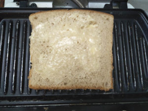 Butter toasting the sandwich