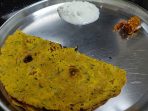 Thalipeeth served with curd and mango pickle
